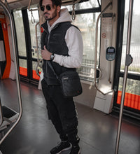 a man standing next to a subway train 